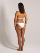 Back view of woman wearing white tie-back triangle bikini top and tie-side bikini bottoms