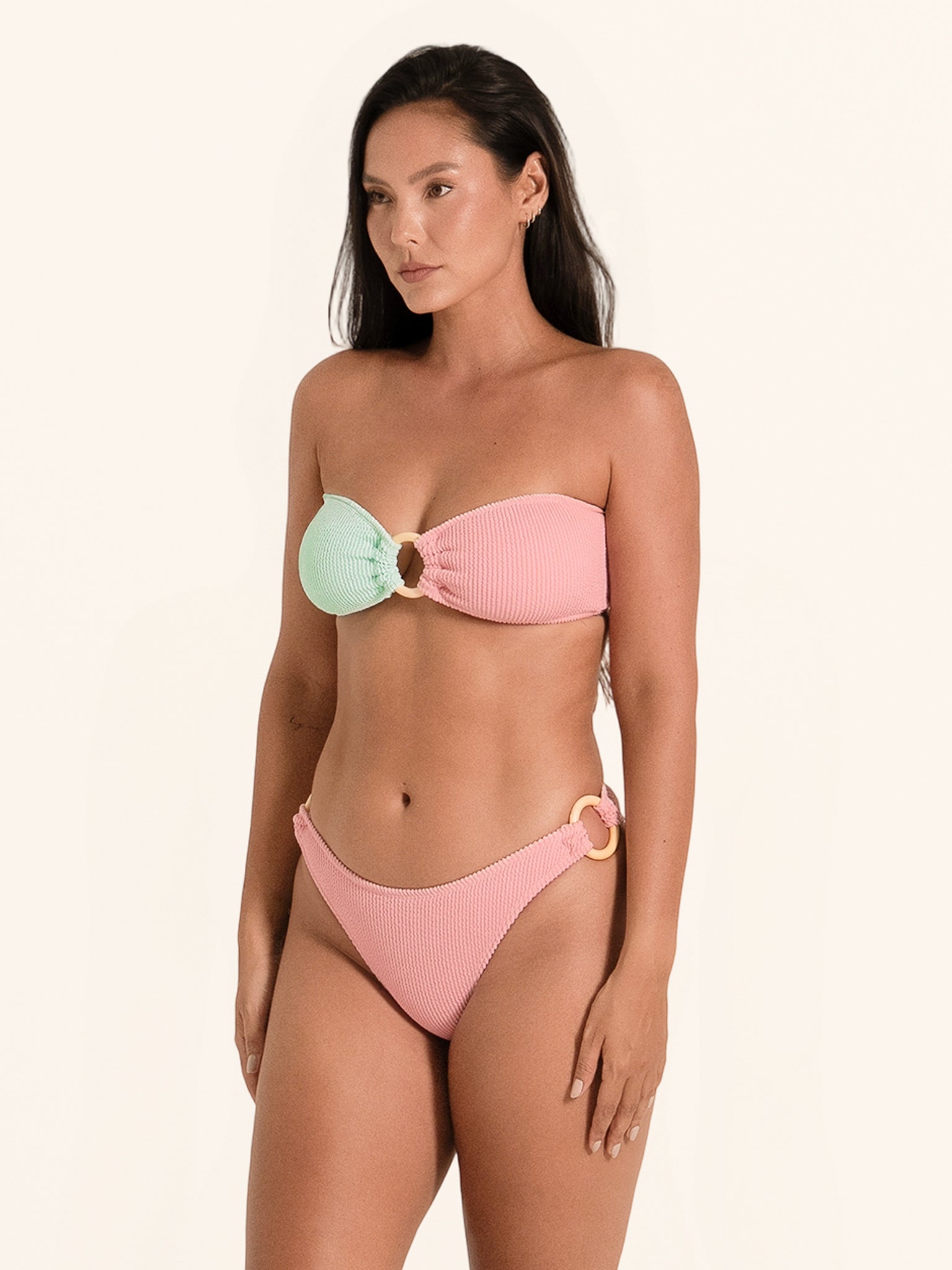 Two-tone bandeau bikini bottom featuring pink and mint green color block.