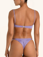 Back view of purple bandeau bikini top with cross strap design.