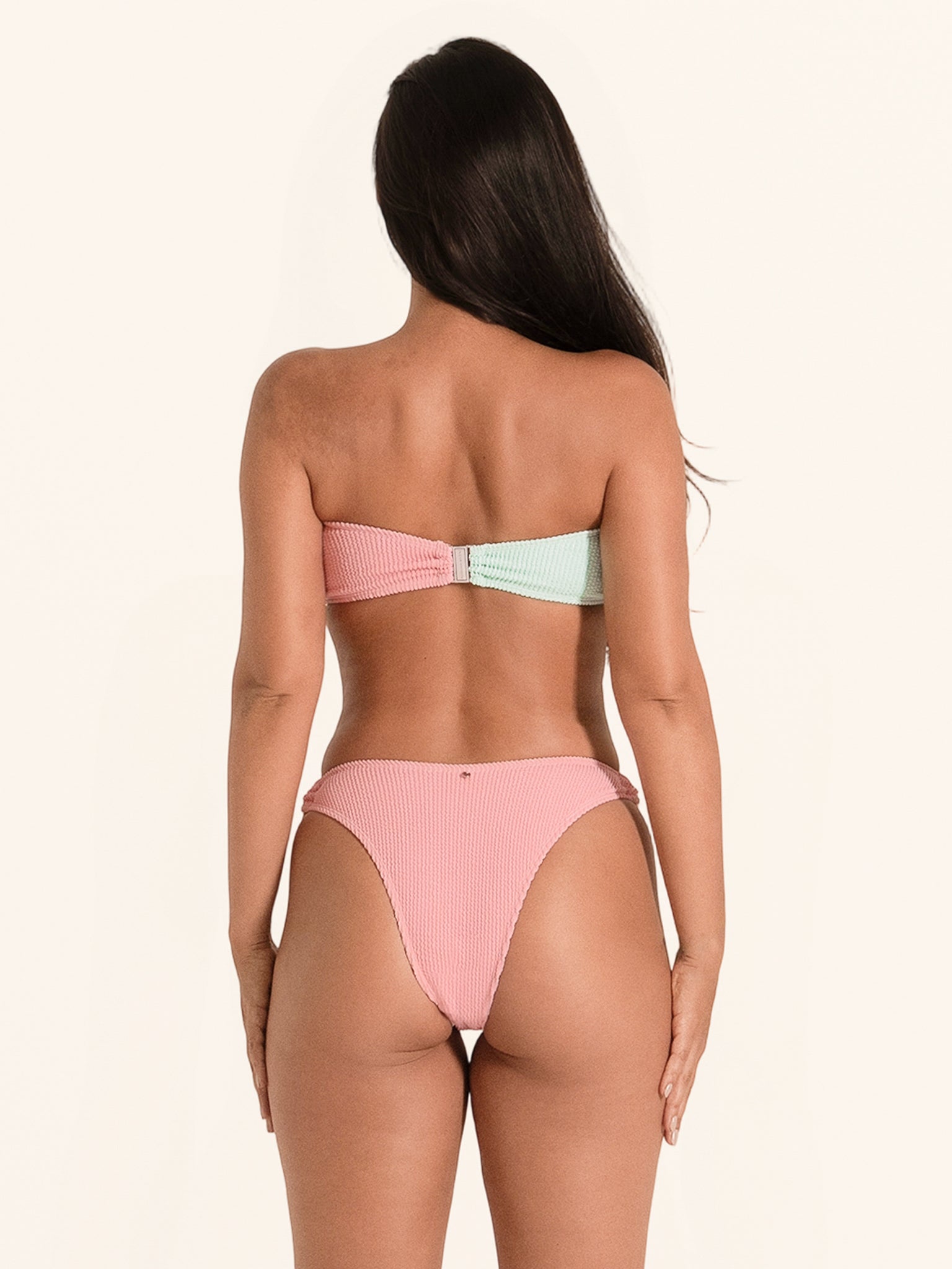 Pink and mint bandeau swim bottom designed with ring detail and sleek lines.