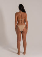 Back view of beige bikini set featuring halter tie neck and back string closure.