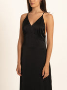 Side profile of black maxi dress with slim spaghetti straps