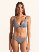 Front view of blue grey bikini top with underwire support and textured fabric.