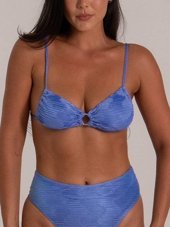 Close-up front view of a blue textured bikini set featuring a ruched ring detail top and high-waisted bottoms