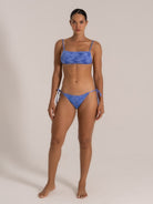Front view of a blue bandeau bikini with tie-side bottoms and camo-like textured fabric.