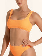 Bright orange ribbed bikini top in a modern sporty cut.