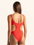 Back view of red textured cut out one piece swimsuit with scoop back and waist cutouts.