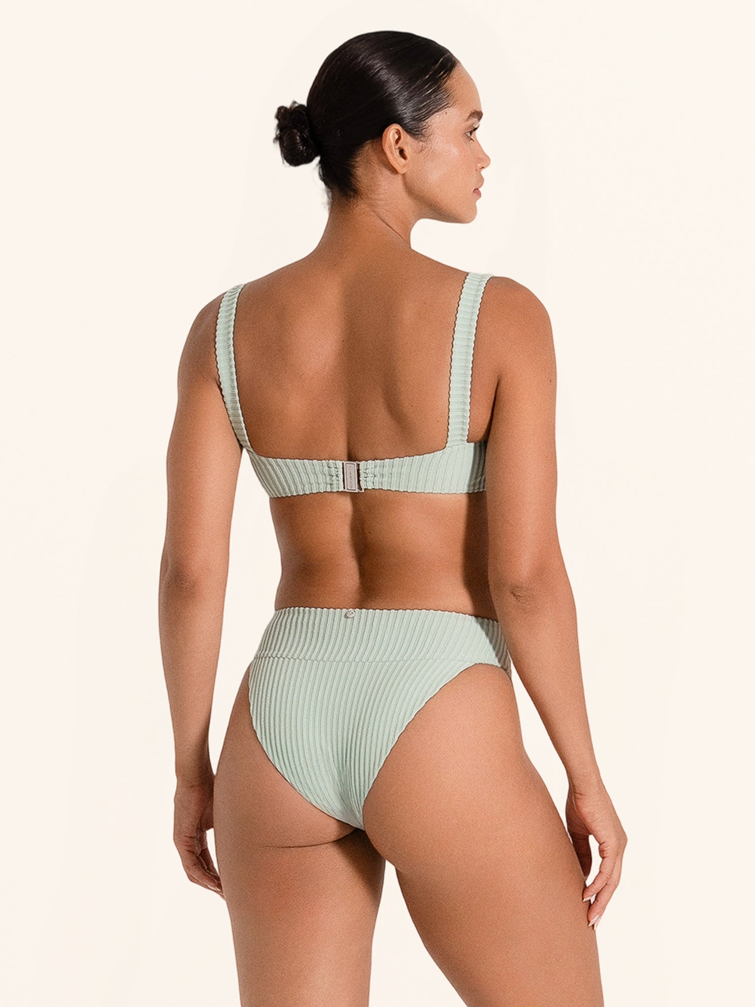 Light green bikini top with supportive ribbed design and clasp back.