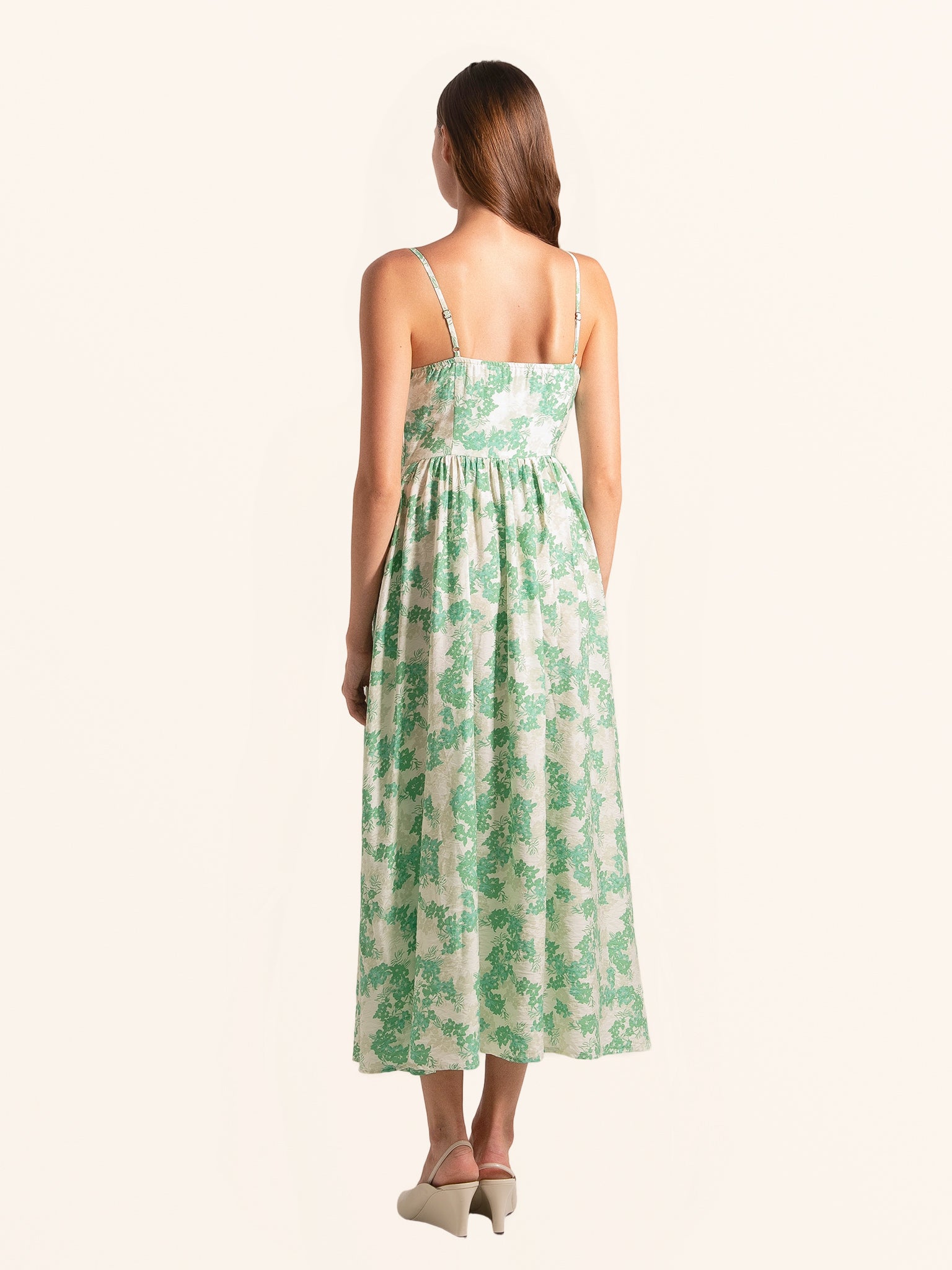 Rear side profile of green floral midi dress with slim straps and relaxed fit