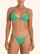 Mid-rise green bikini bottom with modern swim style.