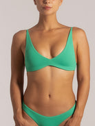 Close-up front view of a woman wearing a green textured bikini with scoop neckline and seamless fit, highlighting the soft fabric and flattering shape.