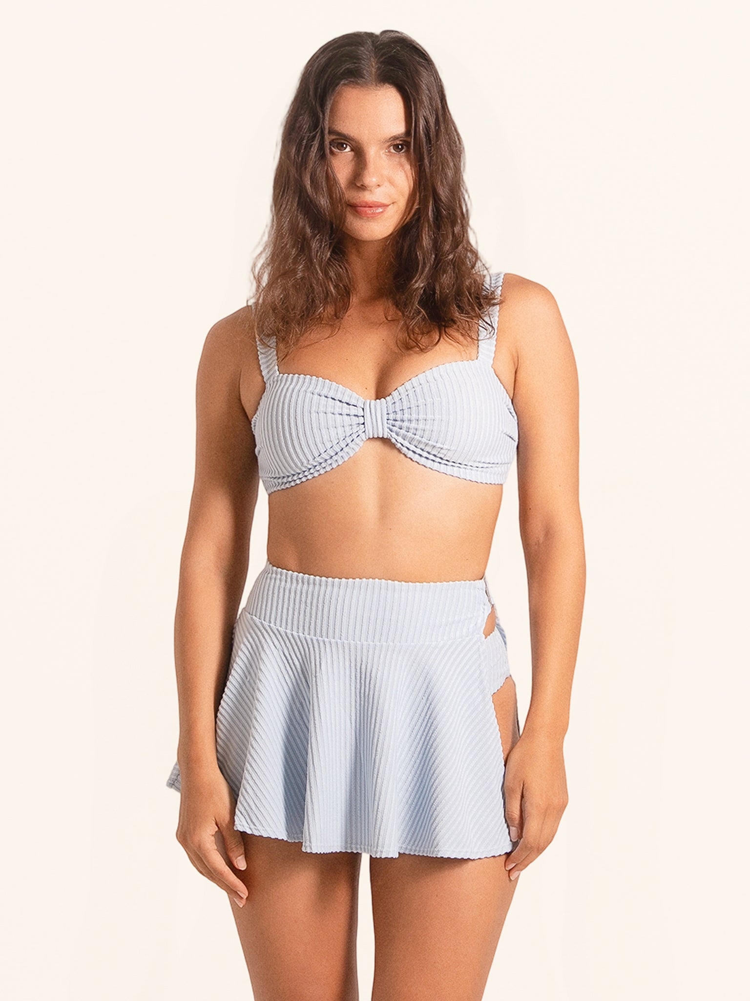 Front view of light blue checkered bikini set with pleated skirt bottom