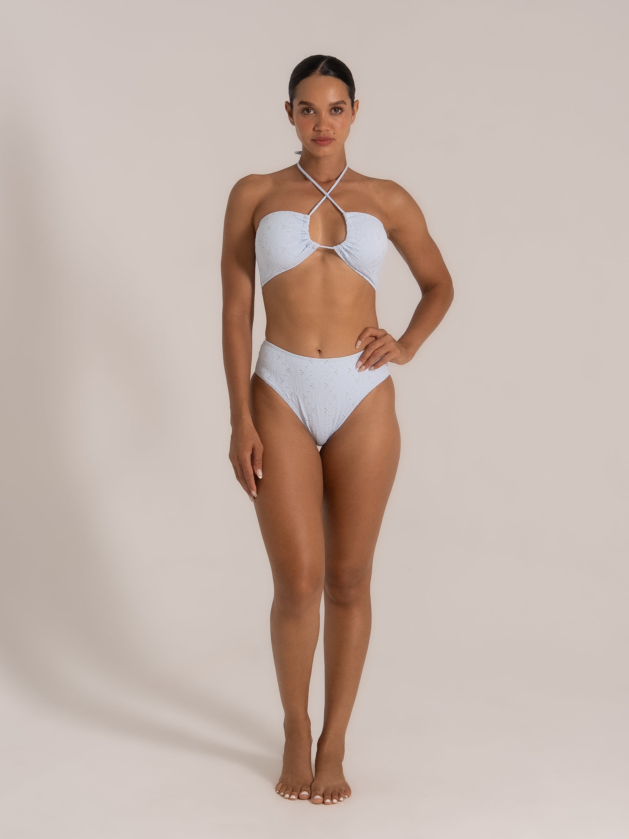 Front view of halter-style cutout bikini in light blue lace with crisscross neckline