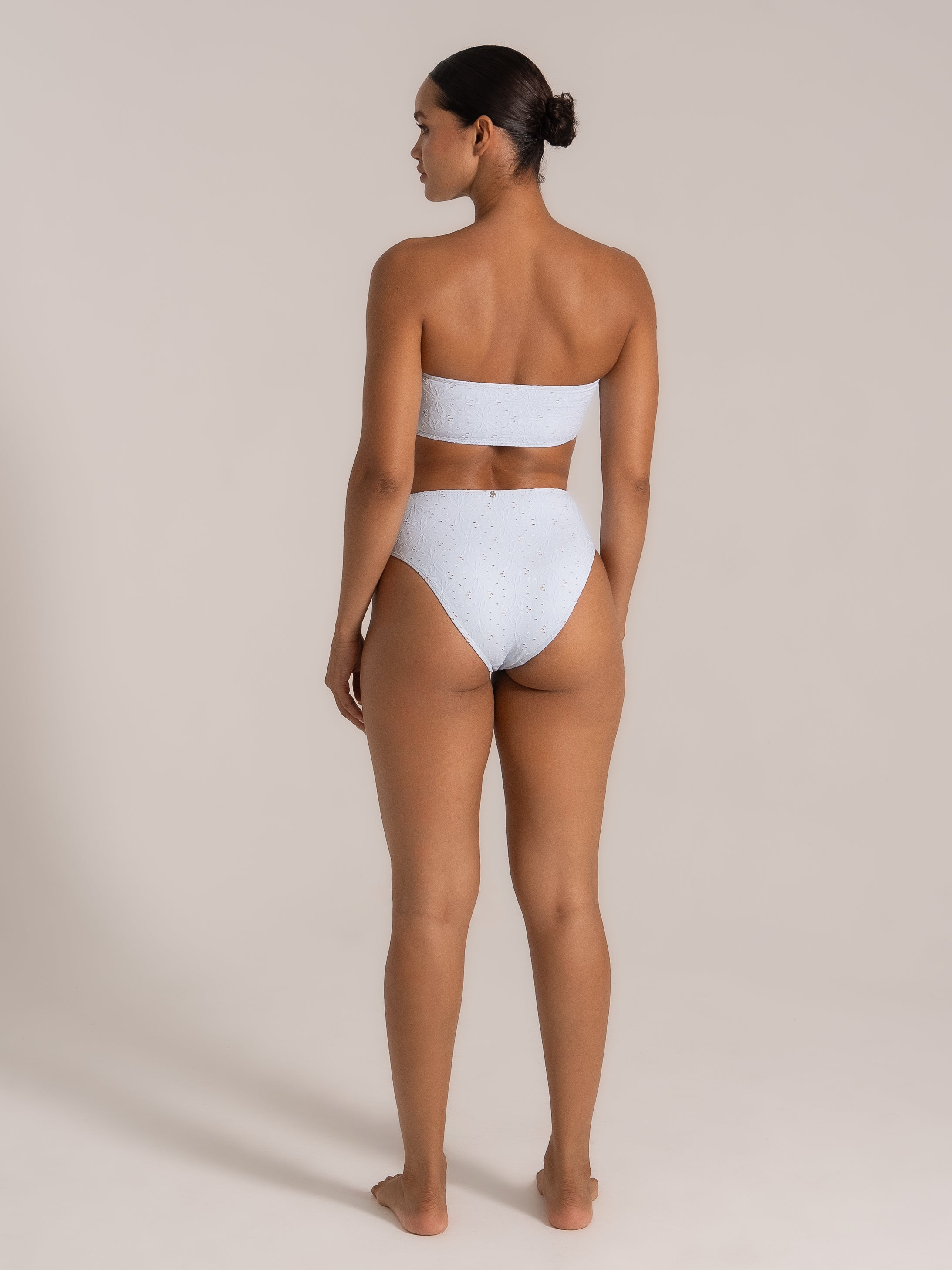 Model wearing light blue strapless lace bikini set from the back