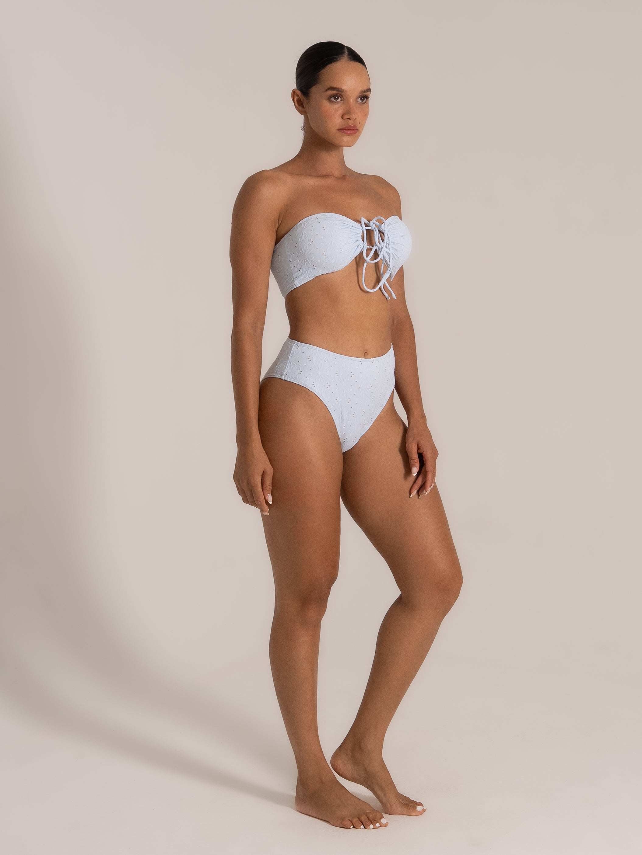 Angled view of strapless bikini in light blue lace fabric