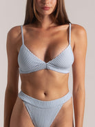 Front view of light blue ribbed bikini set with bralette top and high waisted bottom