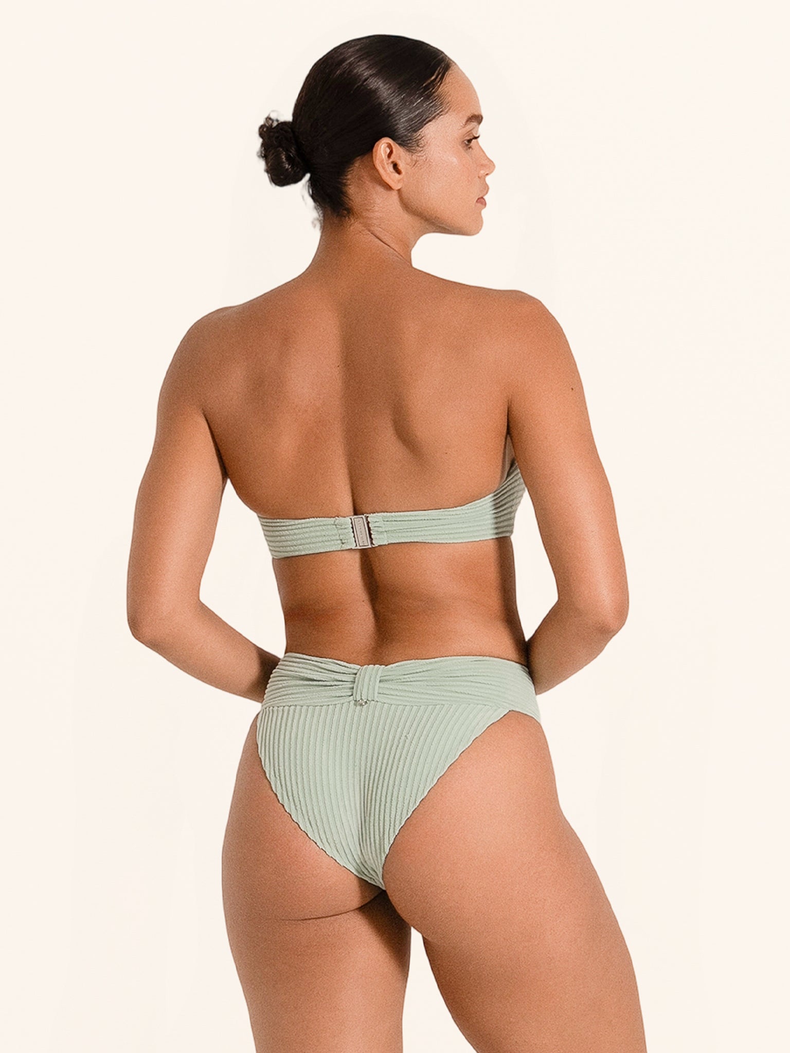 Light green bandeau swim top in resort-ready design with flattering shape.