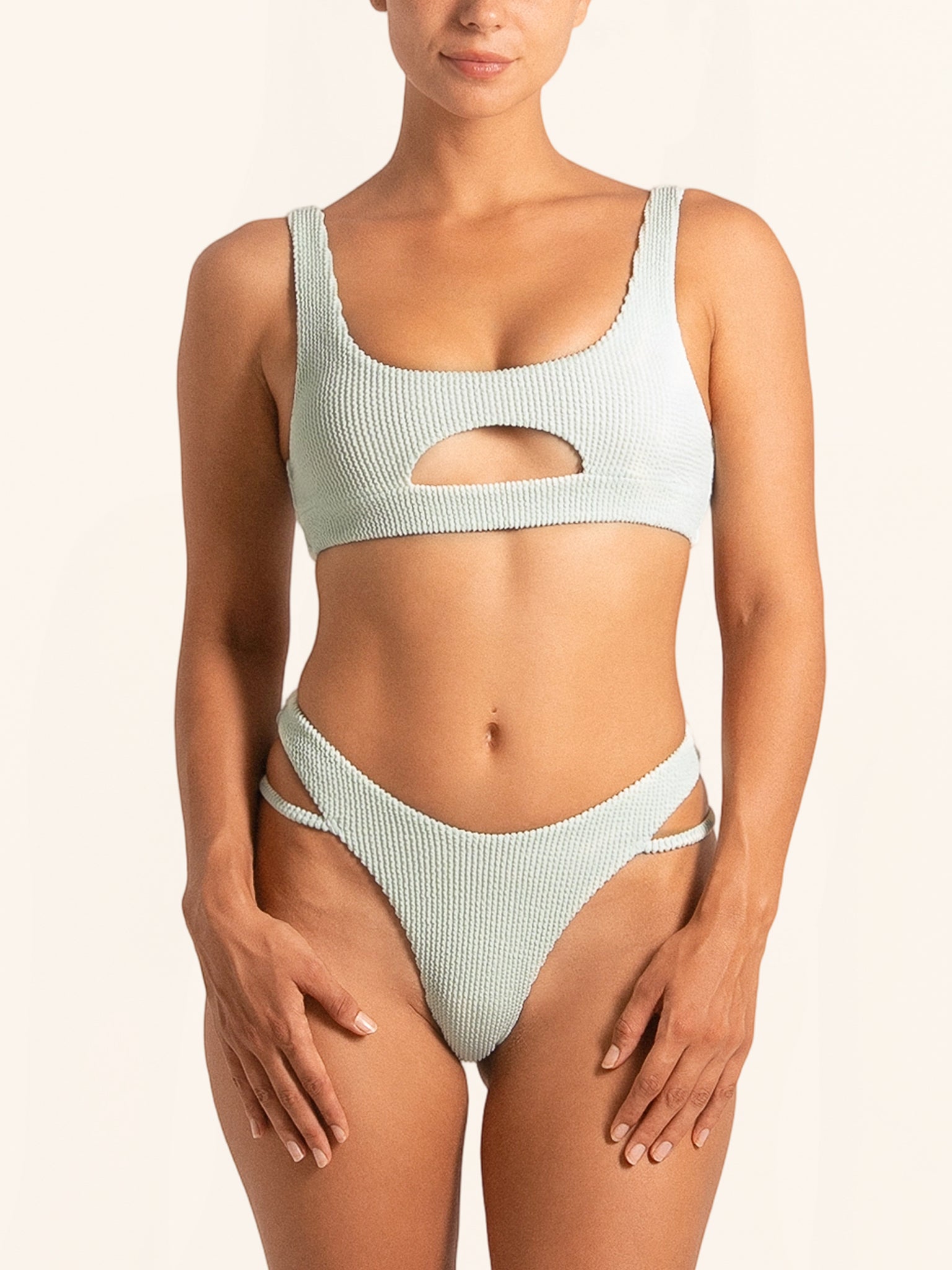 Front view of light green bikini bottom with cut-out waist and high-leg design.