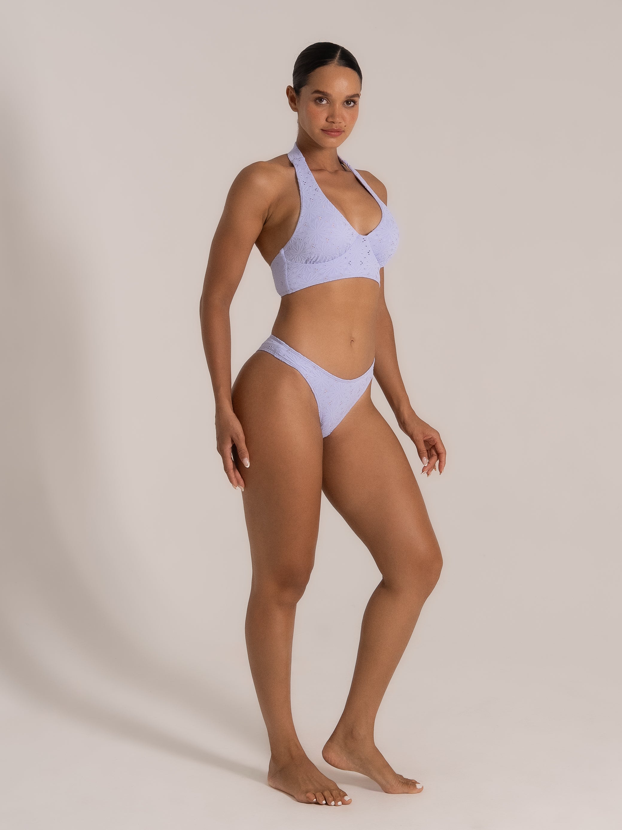 Front angled view of textured lilac halter bikini with high leg bottom