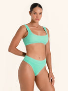 Mint green bikini top with thick straps and scoop neckline.