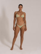 Woman in front pose wearing mint green ribbed triangle bikini with adjustable straps and tie side detail