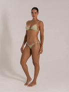 Side view of mint green ribbed swimwear featuring thin adjustable straps and tie side bikini bottoms