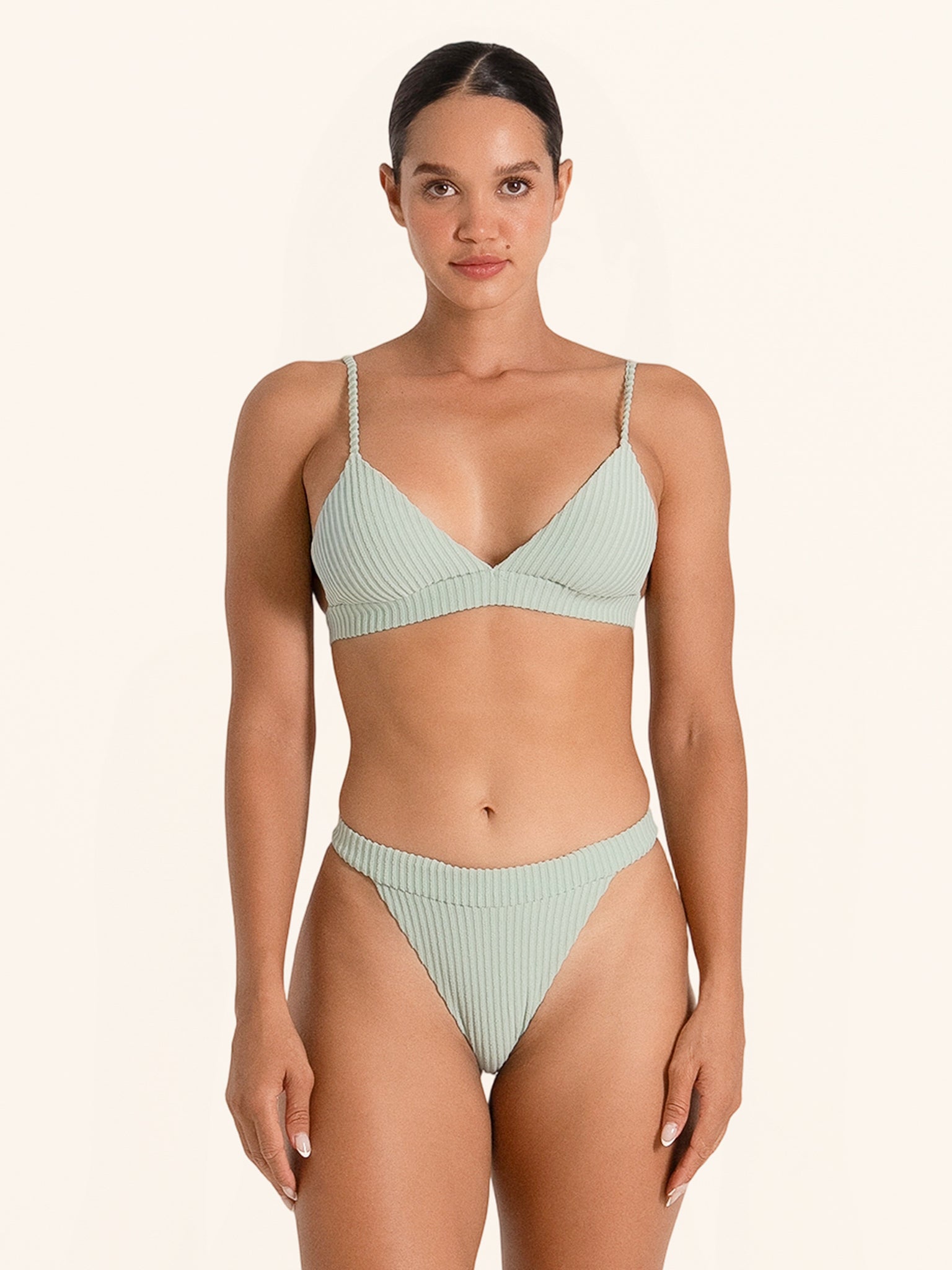 Mint green swimwear triangle top with minimalist design.
