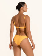 Back angle of mustard yellow bikini top with square neckline and supportive straps.