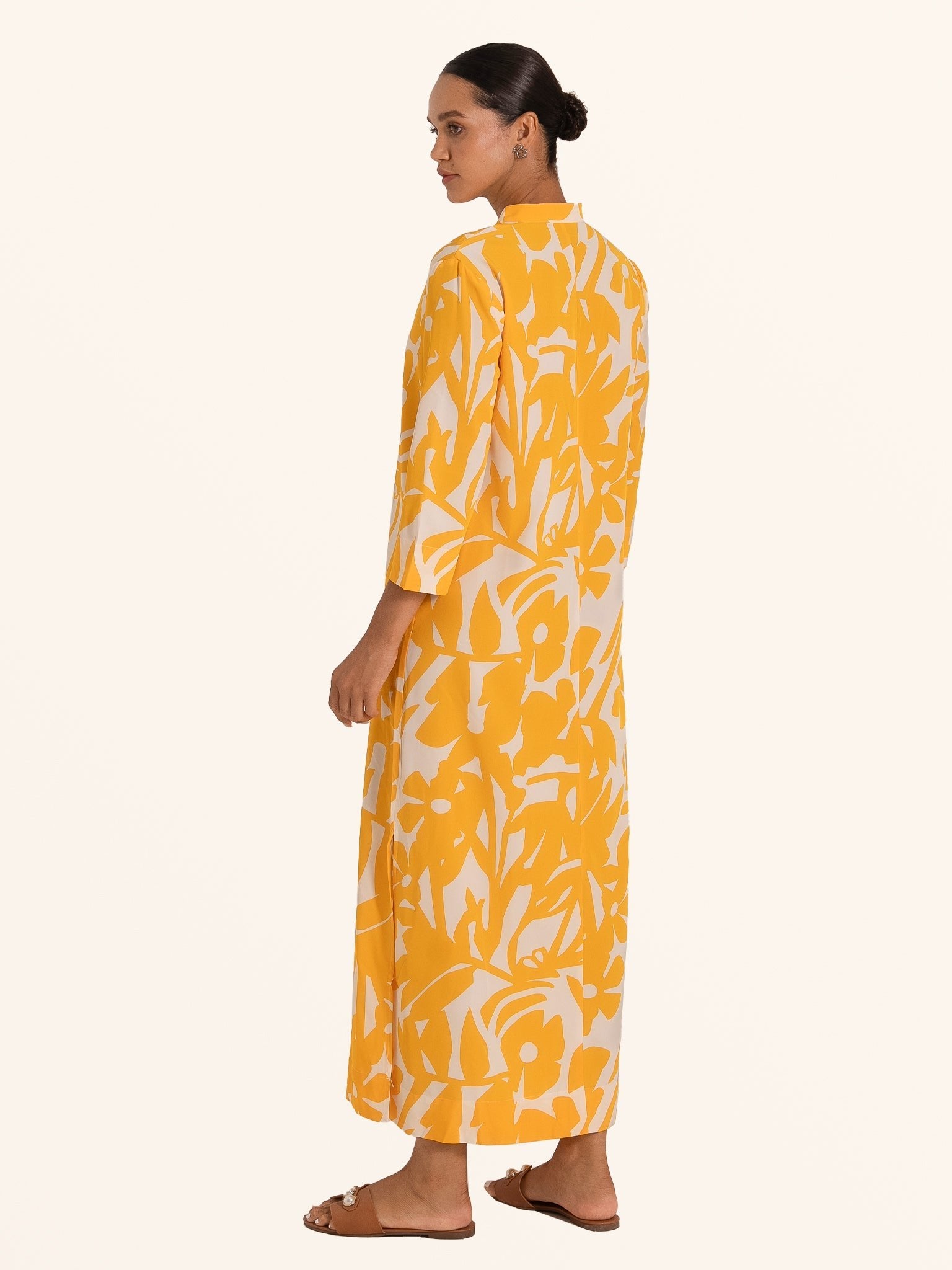 Side profile of mustard yellow print maxi dress with straight hemline