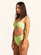 Stylish swim look featuring neon green high-waist bikini bottom.