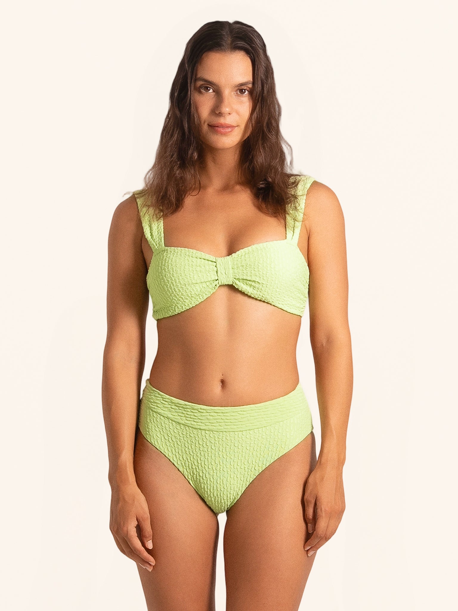 Front view of neon green thick strap bikini top with textured fabric.