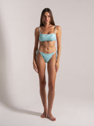 Model wearing aqua blue jacquard bikini front view by Ocean Mystery Swimwear - sustainable textured fabric