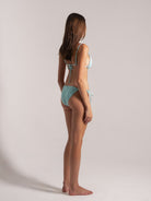 Model wearing aqua blue jacquard bikini side view by Ocean Mystery Swimwear - sustainable textured fabric