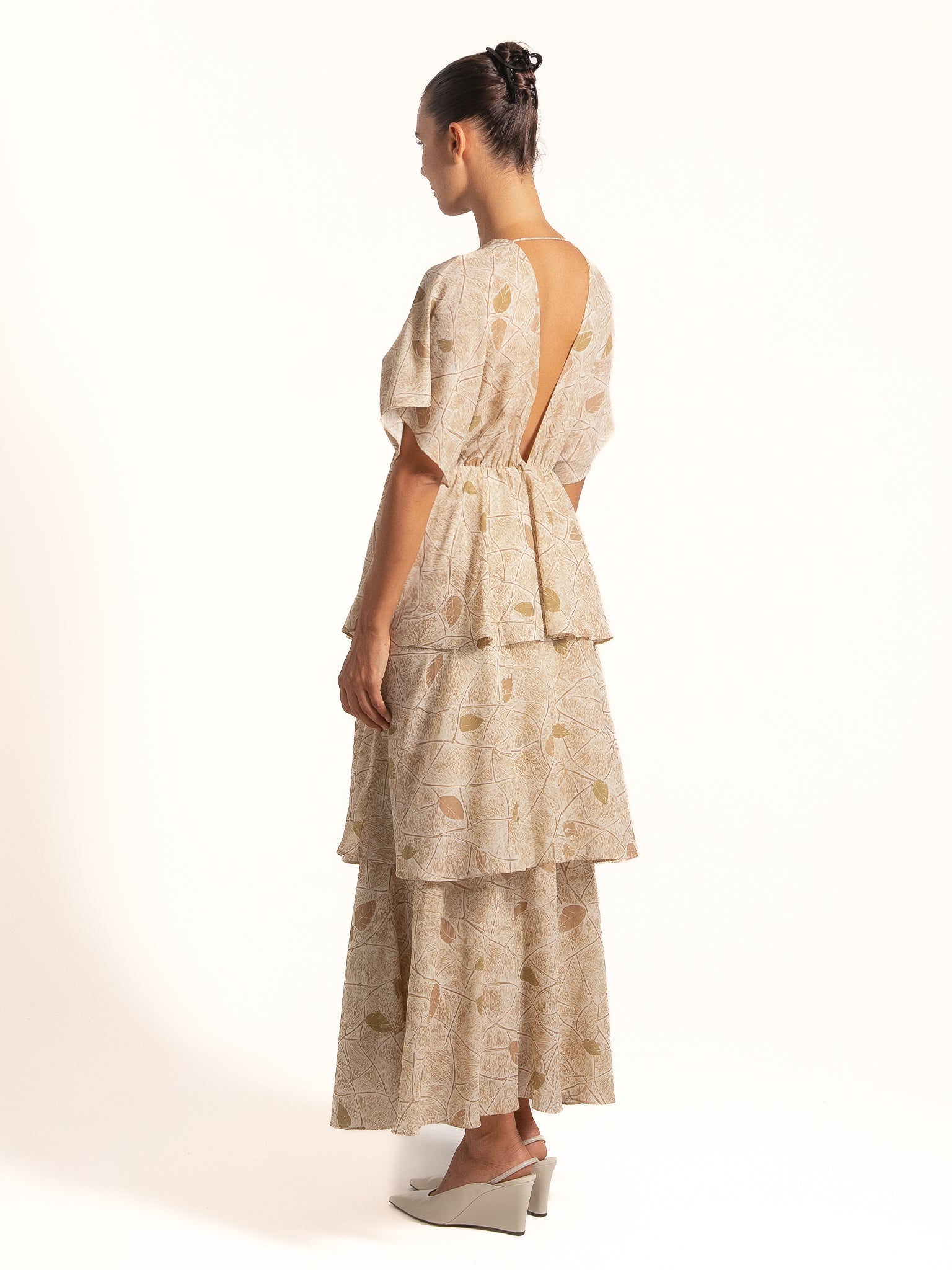 Model wearing Ocean Mystery beige floral layered maxi dress with deep V back and relaxed fit.