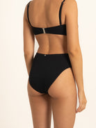 Model wearing Ocean Mystery black bikini bottom with sculpting high leg cut.
