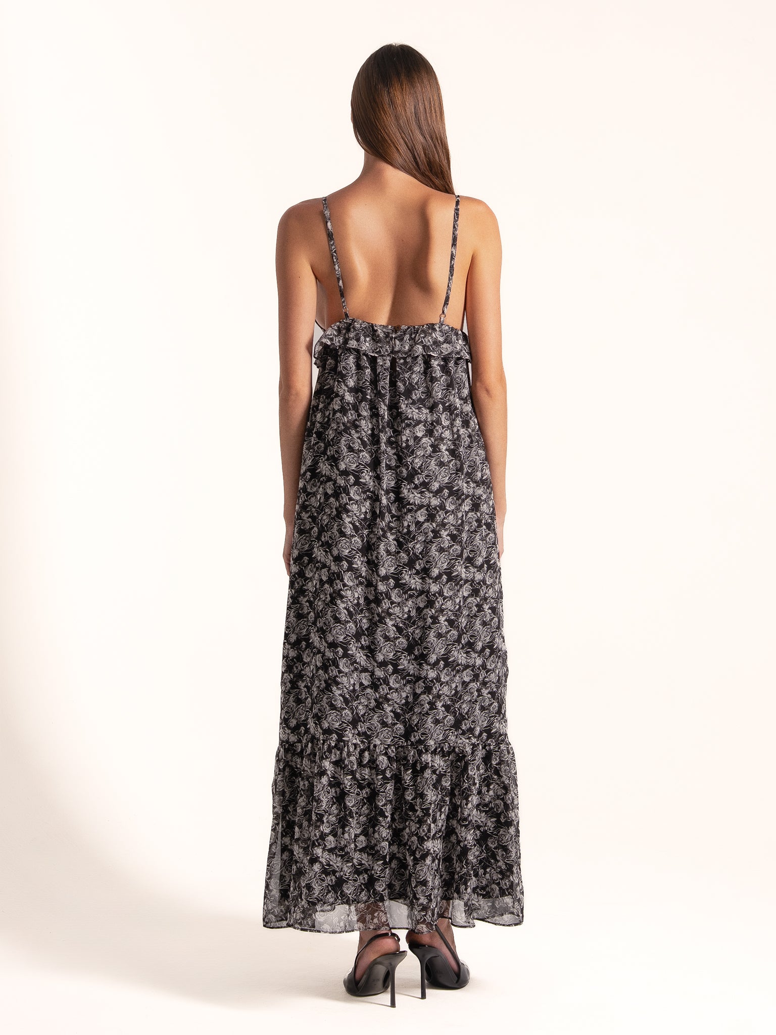 Ocean Mystery black and white floral maxi dress showing adjustable spaghetti straps and tiered hem.