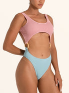 Ocean Mystery cut out one piece swimsuit in pink and light blue with ring detail, side view