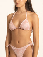 Model wearing Ocean Mystery pink bikini top featuring textured fabric and adjustable straps.