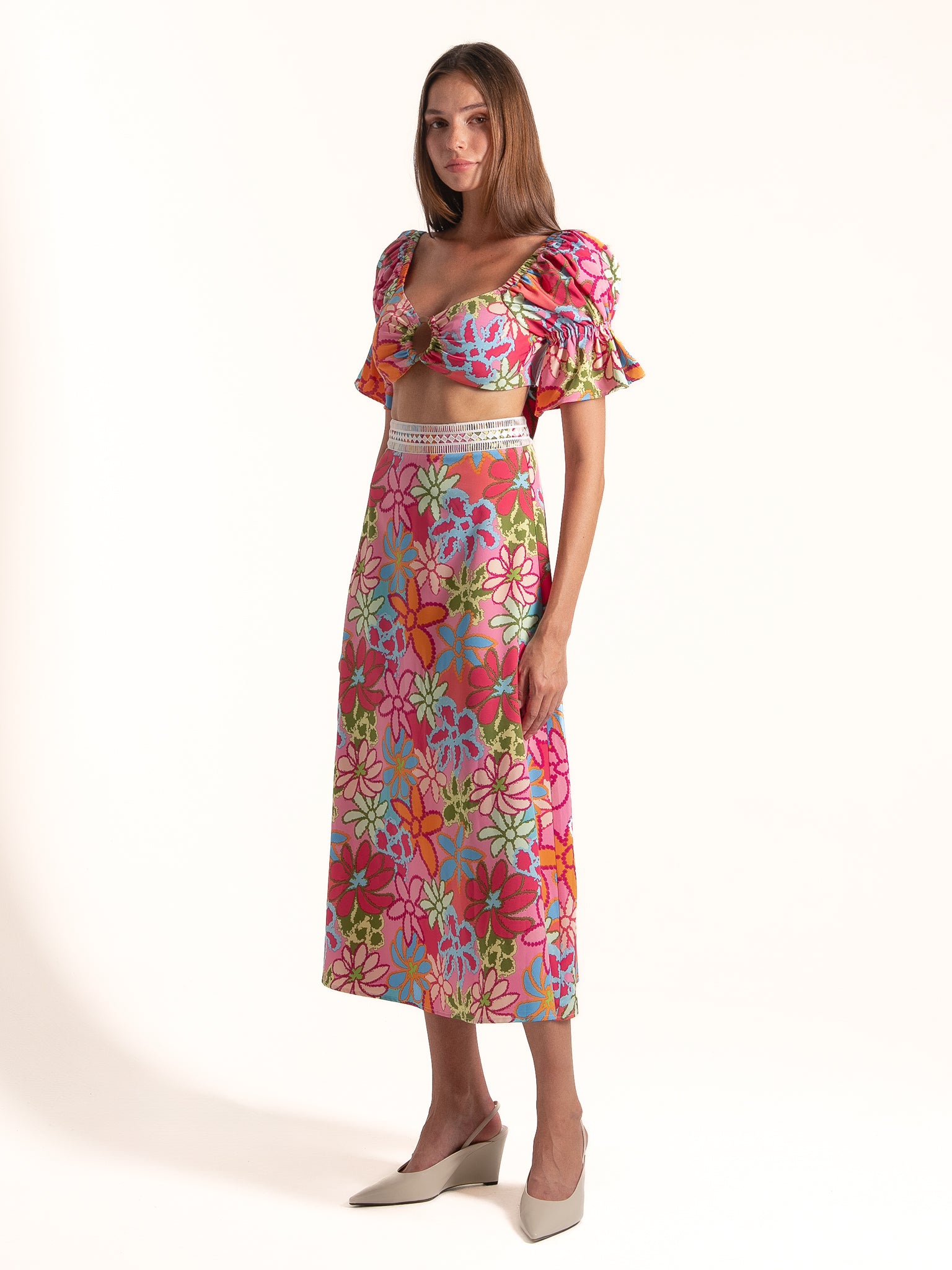 Full length view of Ocean Mystery pink floral puff sleeve midi dress designed for resort and vacation wear.