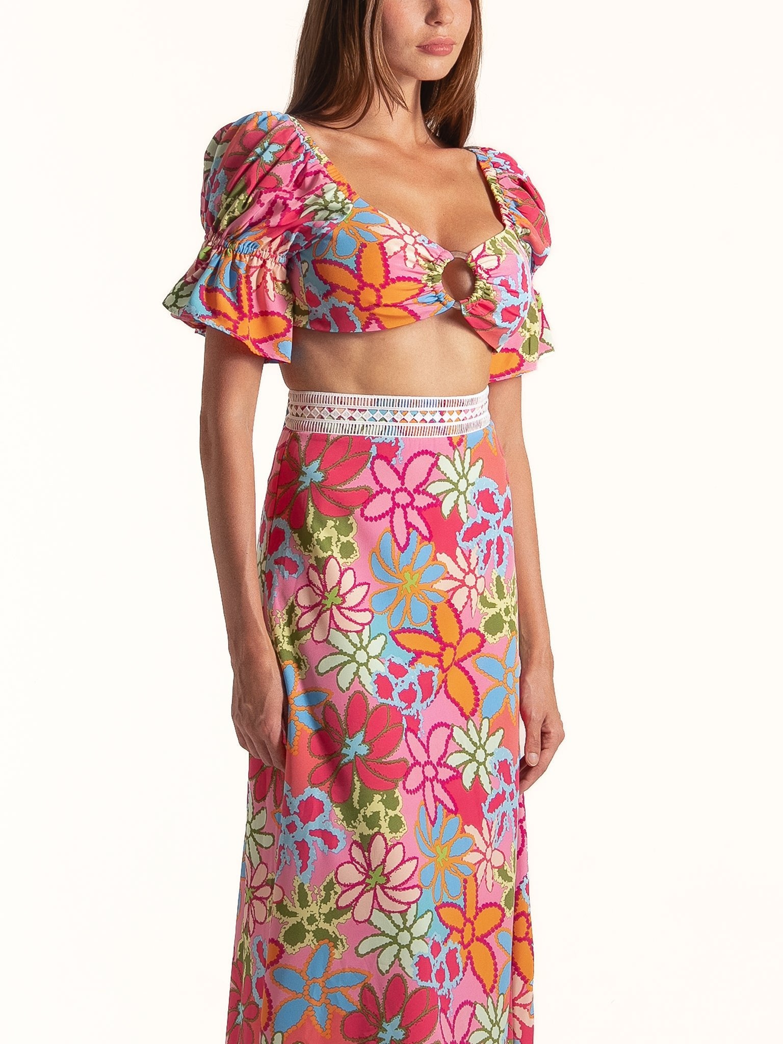 Side view of Ocean Mystery pink floral puff sleeve midi dress featuring bright flower prints and fitted waist.