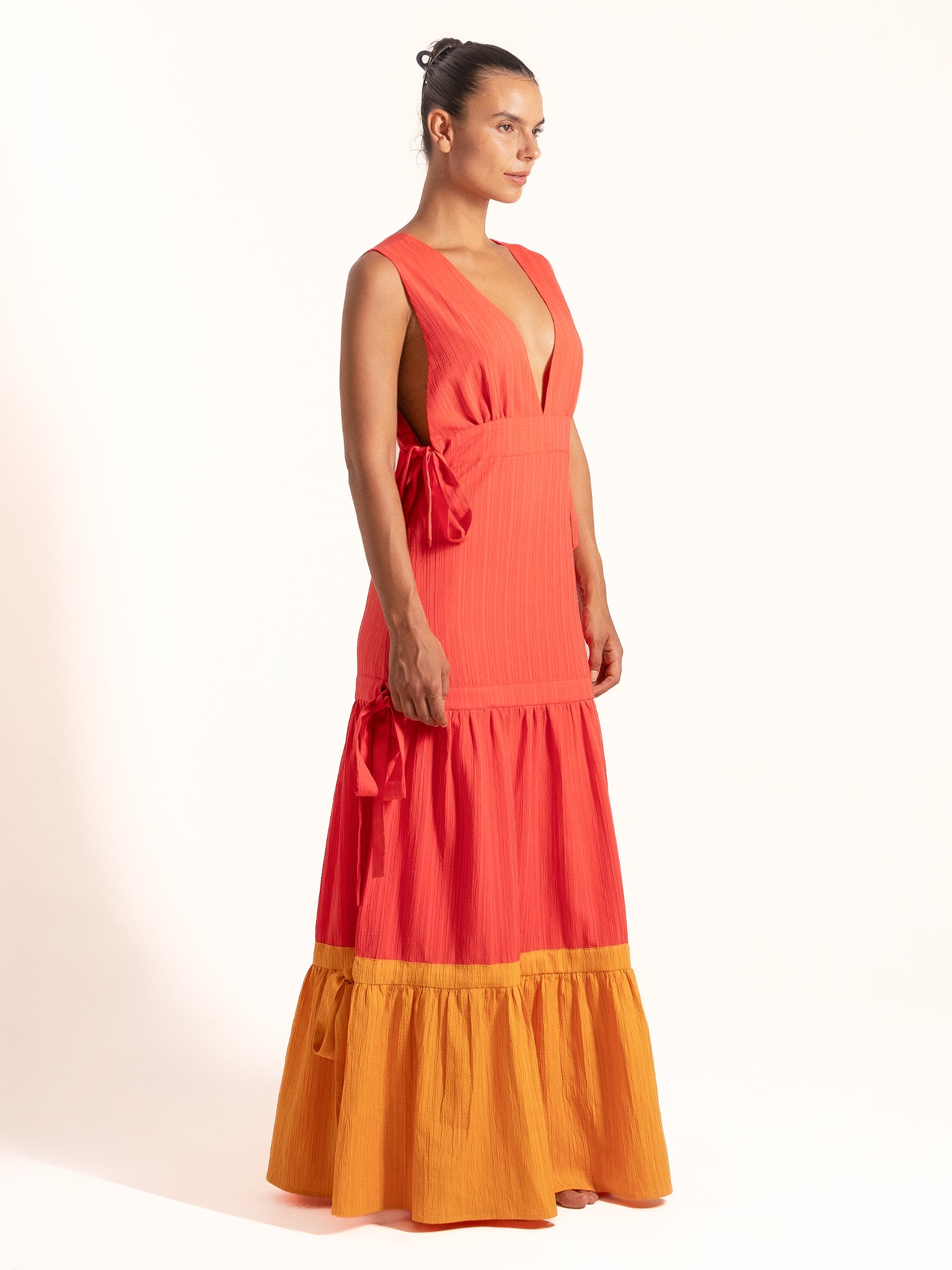 Full length view of Ocean Mystery red and mustard yellow color block maxi dress with flowy tiered skirt.