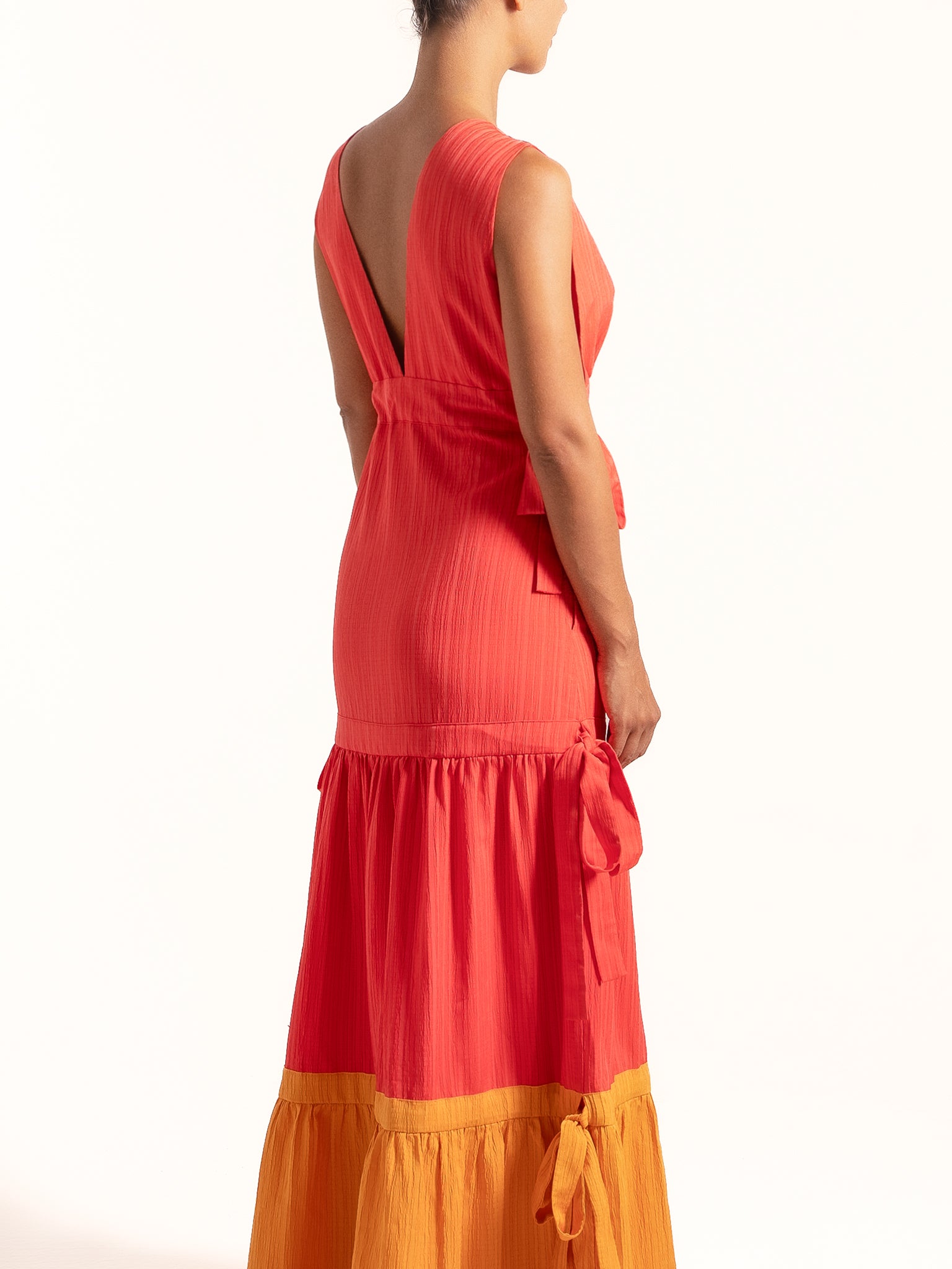 Back angle of Ocean Mystery red and mustard yellow tiered maxi dress featuring deep V back.