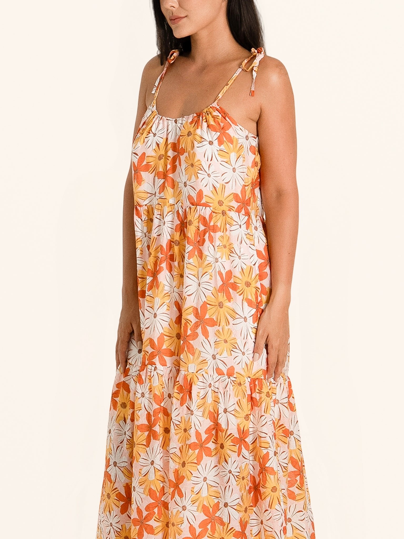 Side profile of orange floral maxi dress with relaxed fit and floral print
