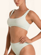 Pastel green bikini top featuring wide straps and a supportive cut.