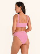 Pink bikini top with wide straps and square cut back for a flattering fit.