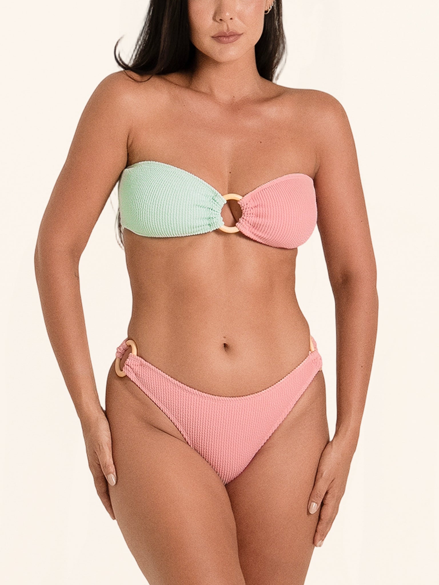 Pink and mint green bandeau bikini bottom with contrast design and cheeky fit.
