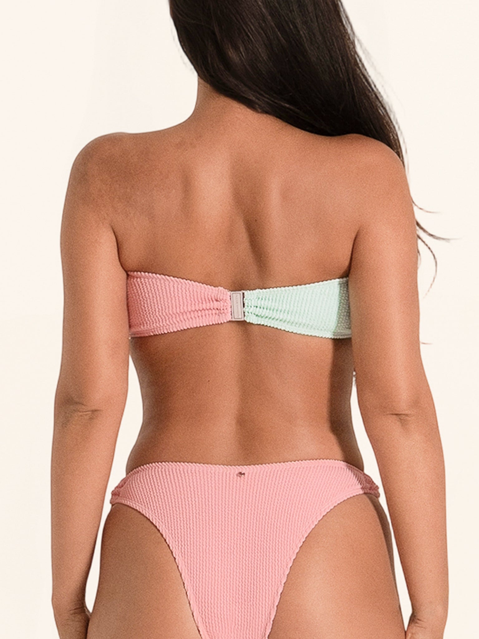 Pink and mint green bandeau bikini top with ring detail and strapless style.