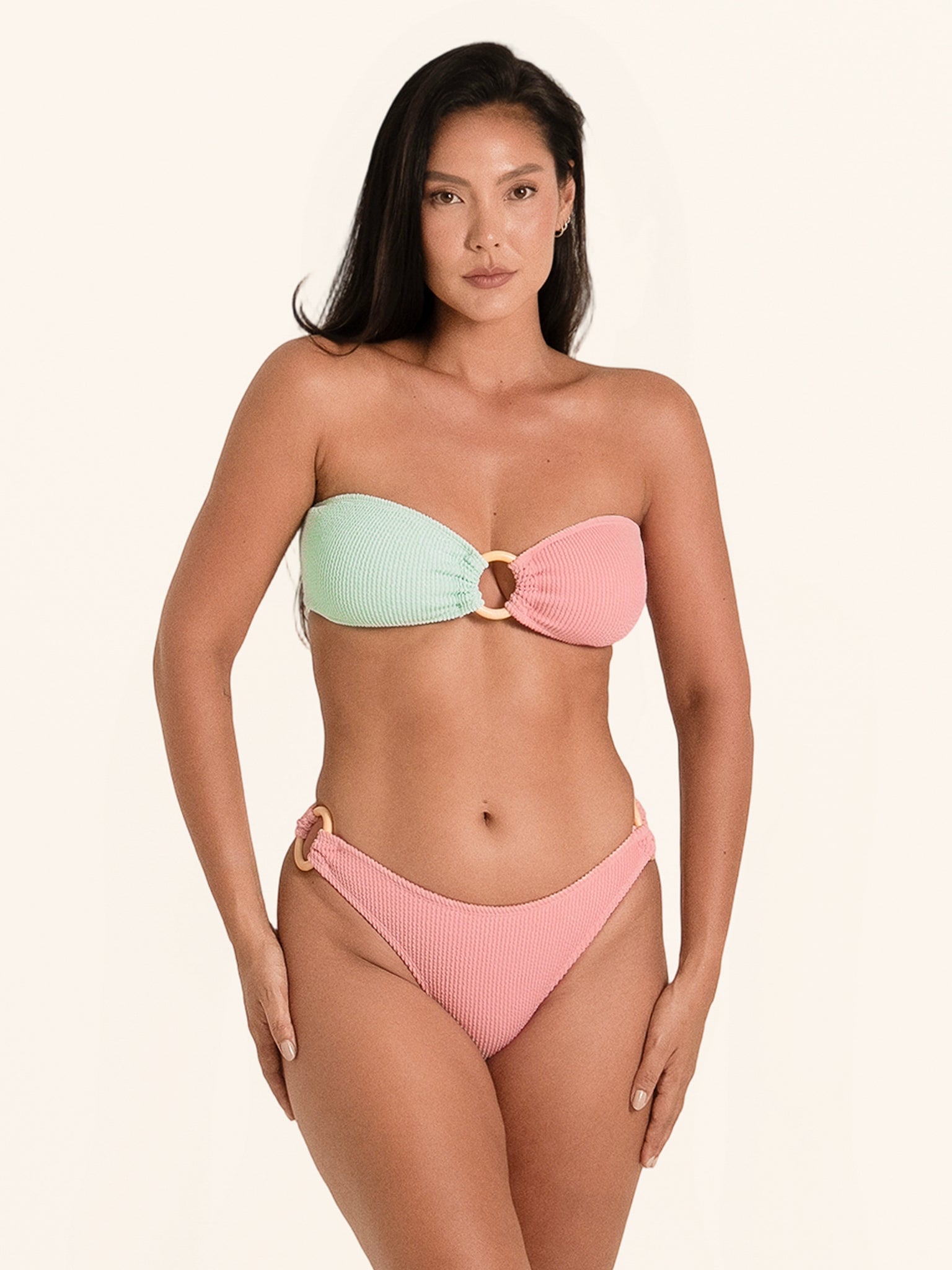 Pink and mint bandeau top for a playful and modern summer bikini look.