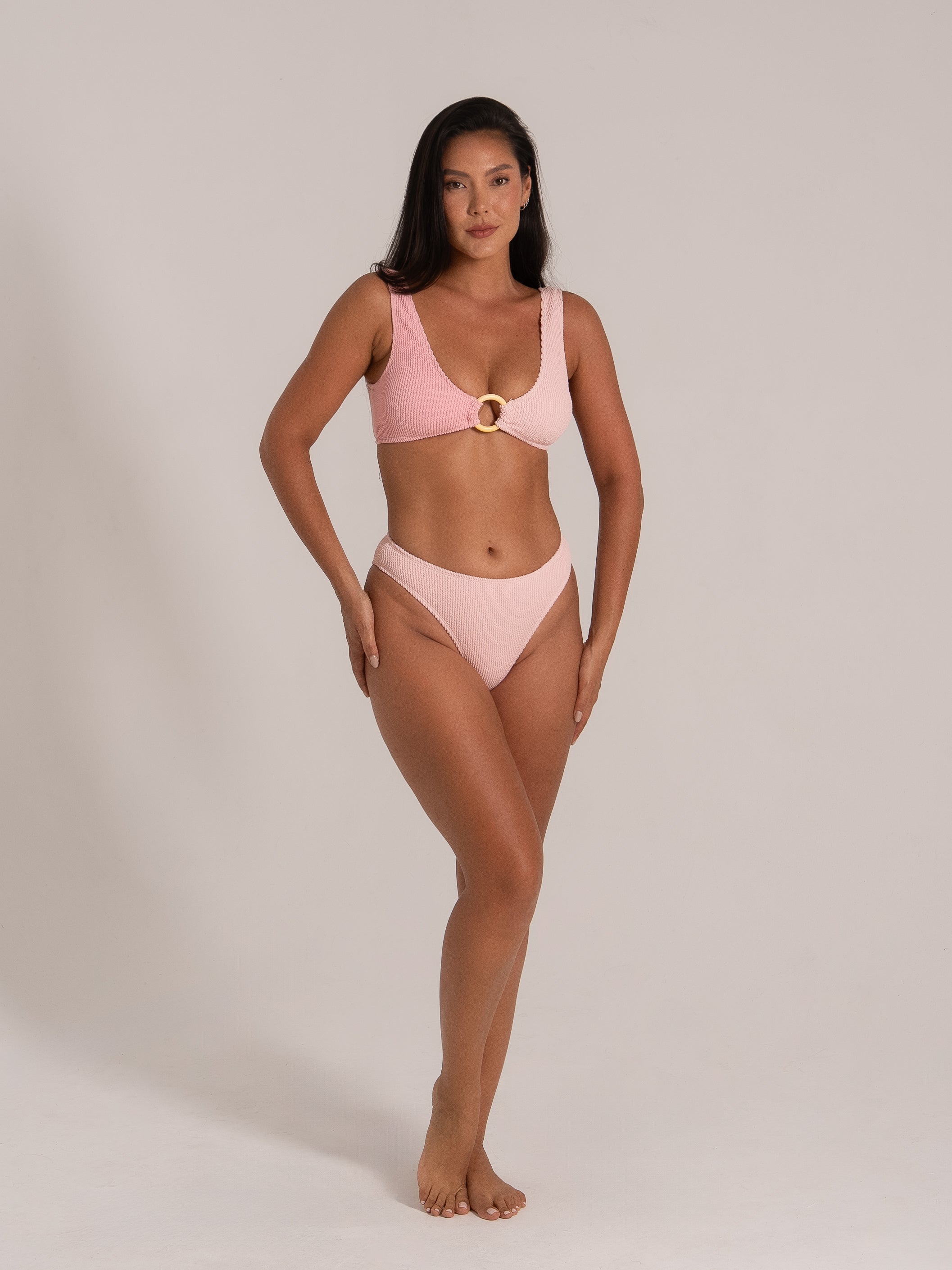 Front view of a model wearing a pink ring bikini set with scoop neckline and high-cut bottoms.