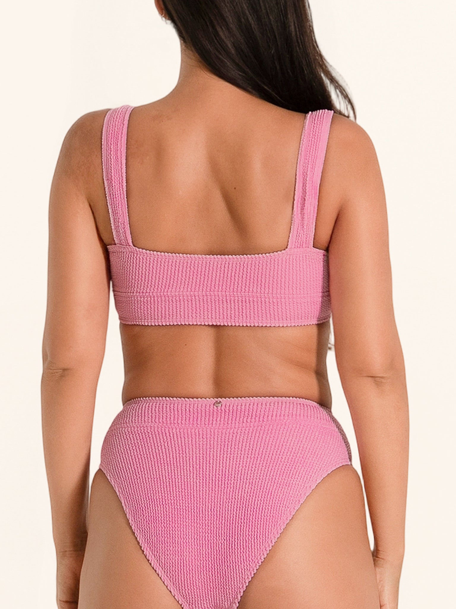 Swimwear bikini top in pink with ribbed fabric, wide straps, and a square back.